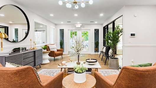 a living room with furniture and a large mirror