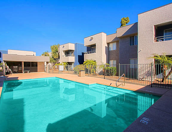 a swimming pool in front of an apartment building
