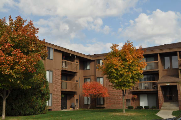 Exterior brick building with landscaped courtyard at Dover Hills Apartments in Kalamazoo, Michigan