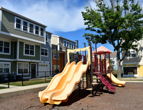 a playground with slides in front of houses