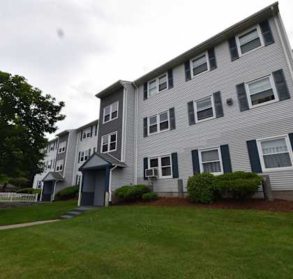 an apartment building with a yard in front of it