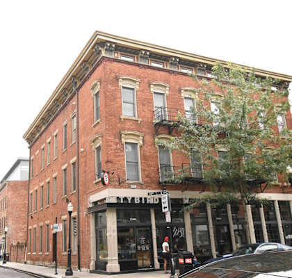 an old brick building on the corner of a city street