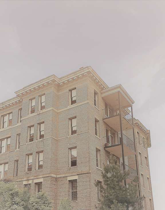 the top of a brick building with a fire escape