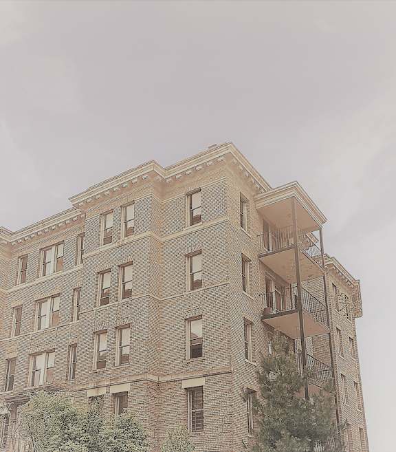 the top of a brick building with a fire escape