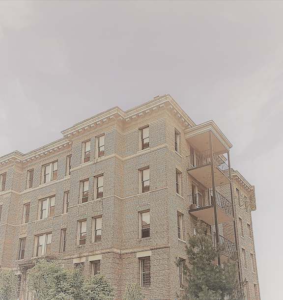 the top of a brick building with a fire escape