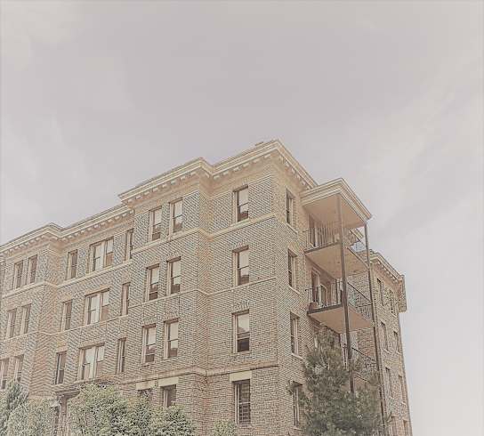 the top of a brick building with a fire escape