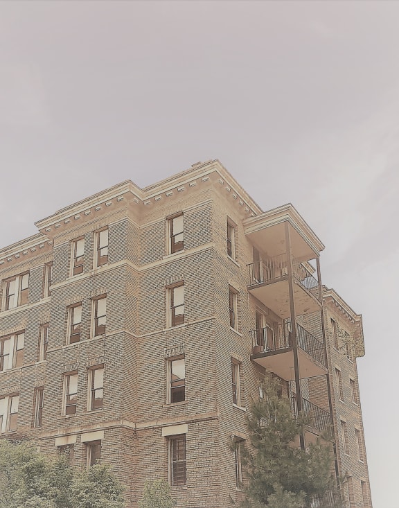 the top of a brick building with a fire escape