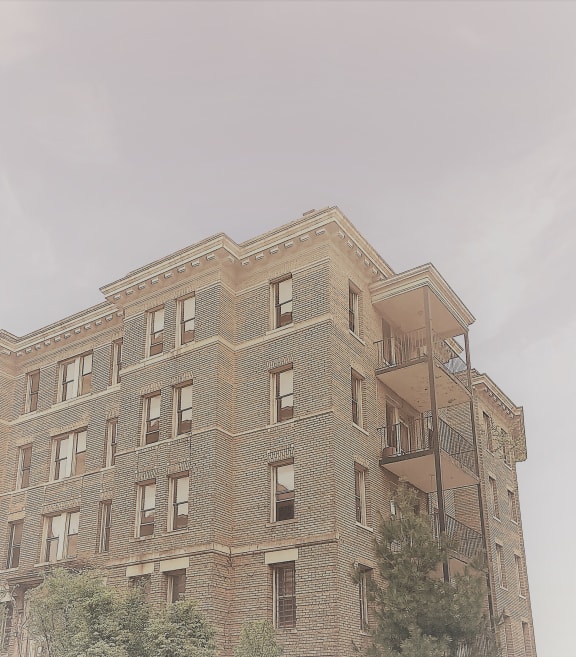 the top of a brick building with a fire escape