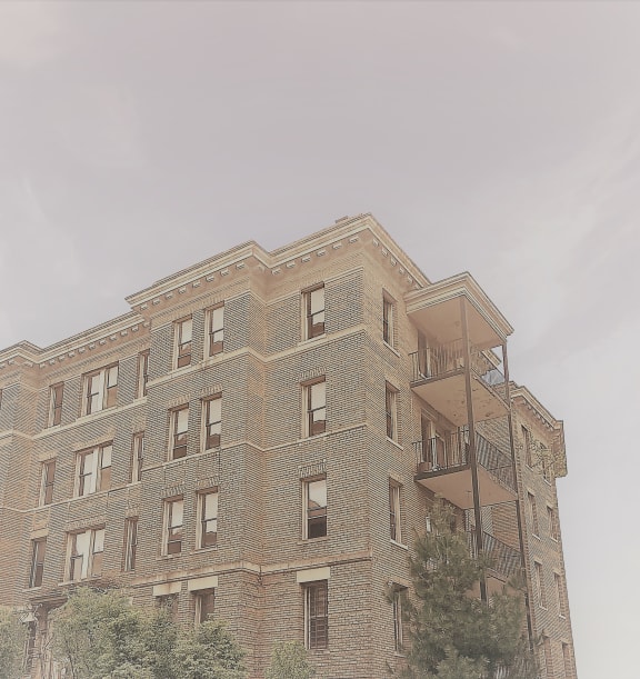 the top of a brick building with a fire escape