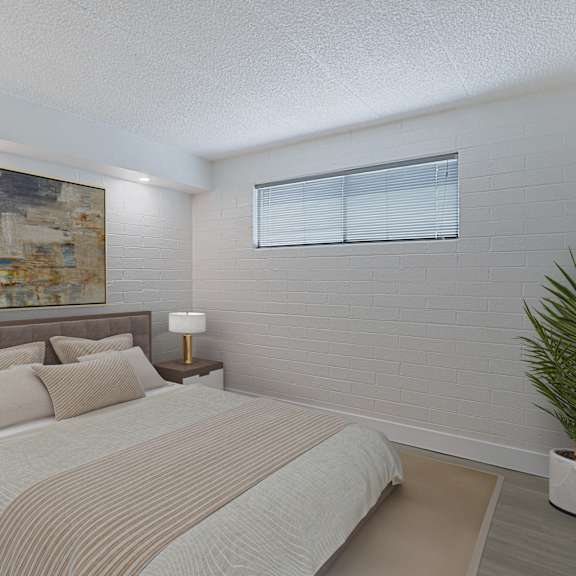 a bedroom with a bed and a potted plant