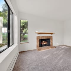 a living room with a fireplace and a window