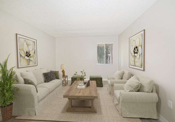 A living room with a couch, chairs, and a coffee table.