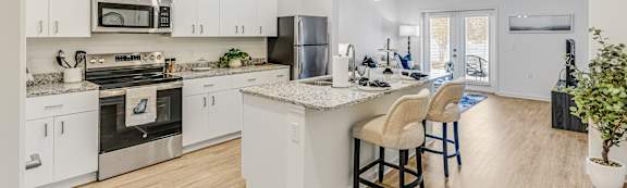 A modern kitchen with white cabinets and a center island.