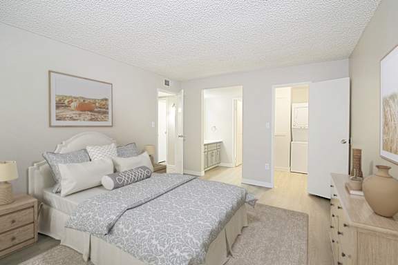 A bedroom with a large bed and a painting on the wall.