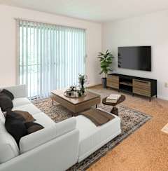 a living room with a white couch and a television