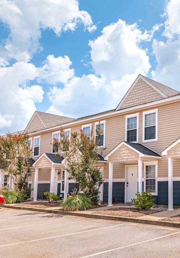 an empty street in front of a building with a sign on the side at Sterlington Apartments, Grovetown, GA, 30813