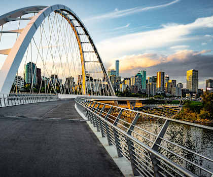 A bridge with a metal railing and a roadway.