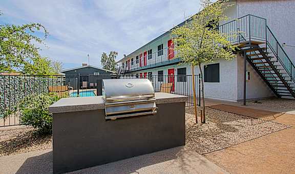 A silver car is parked on a concrete block.