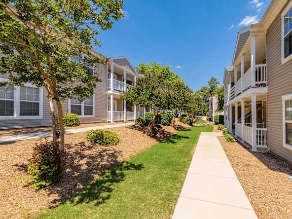 an open kitchen and living room with a table and chairs at Sanctuary Apartments & Townhomes, Augusta