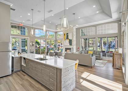 A modern kitchen with a large island and stainless steel appliances. at Country Club Lakes, Jacksonville, FL