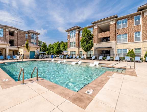 A swimming pool in front of a residential building.