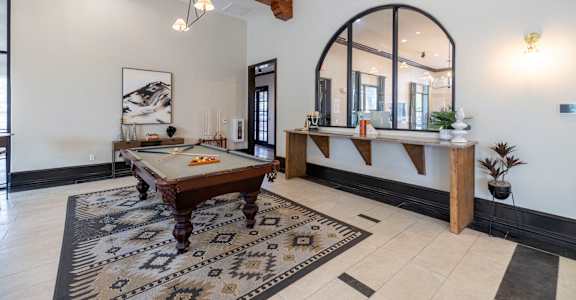 a game room with a pool table and a bar