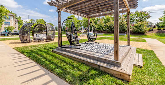 A wooden structure with a canopy and a bench underneath it.