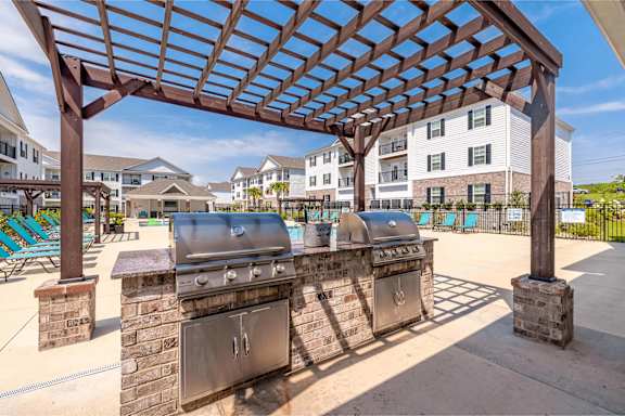 A patio with a grill and a pergola at The Vista Apartments & Townhomes, Warrenville, SC, 29851