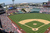 A baseball stadium is filled with fans watching a game.