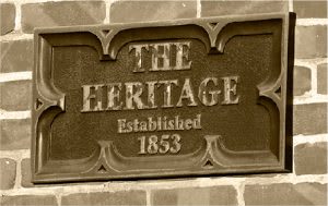 A plaque on a wall that says "The Heritage Established 1853".