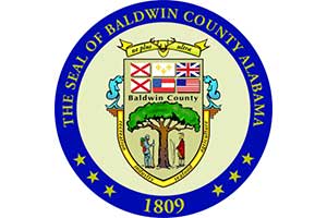 The seal of Baldwin County Alabama features a tree, a man and a woman, and the year 1809.
