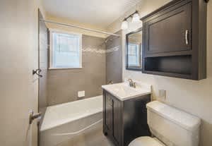 Bath tub area with sink and vanity at Rivercrest Apartments, New Jersey, 08854