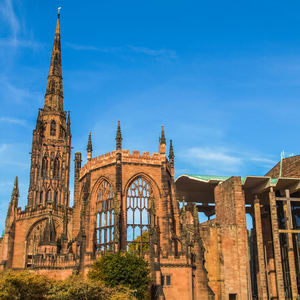 A large, historic cathedral with a tall spire and a large rose window dominates the skyline.