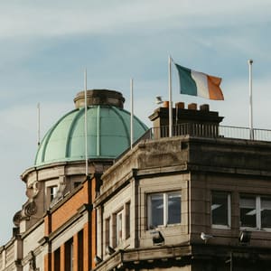 A building with a green dome and a flag on top.