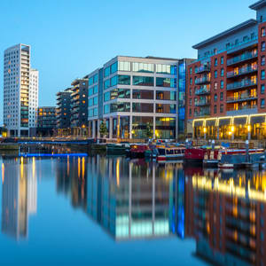 A cityscape with buildings and boats on the water.