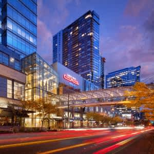 a city street at night with tall buildings at Two Lincoln Tower Apartments, Bellevue, WA, 98004