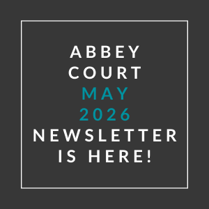 A black background with text announcing the May 2026 newsletter for Abbey Court.