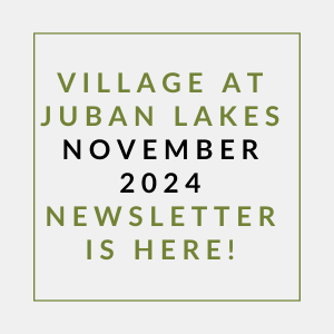 a white and green sign with the words village october 2024