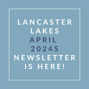 A blue square with white text announcing the Lancaster Lakes April 2024 newsletter.