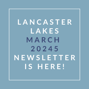 A blue square with white text announcing the Lancaster Lakes March 2024 Newsletter.