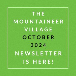 a green field with the words the mountaineer village october 2024 is here