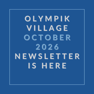 A blue square with white text announcing the Olympik Village October 2026 newsletter.