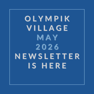 A blue square with white text announcing the Olympik Village May 2026 newsletter.