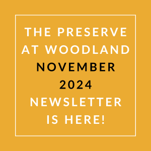 the white text on an orange background says the preserve at woodland november 24
