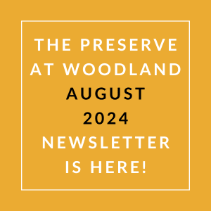 the orange background with white text and the words the preserve at woodland august 24