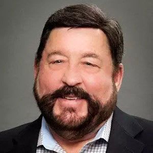a man with a beard in a suit