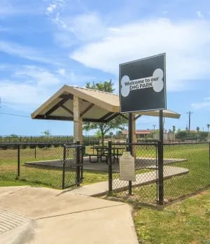 a dog park with a sign that says welcome to our dog park