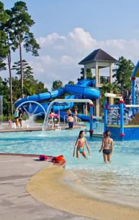 a group of children playing in a water park