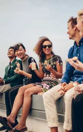 a group of people sitting on top of a bench