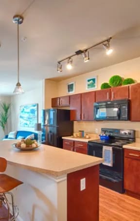 a kitchen with a center island next to a stove top oven
